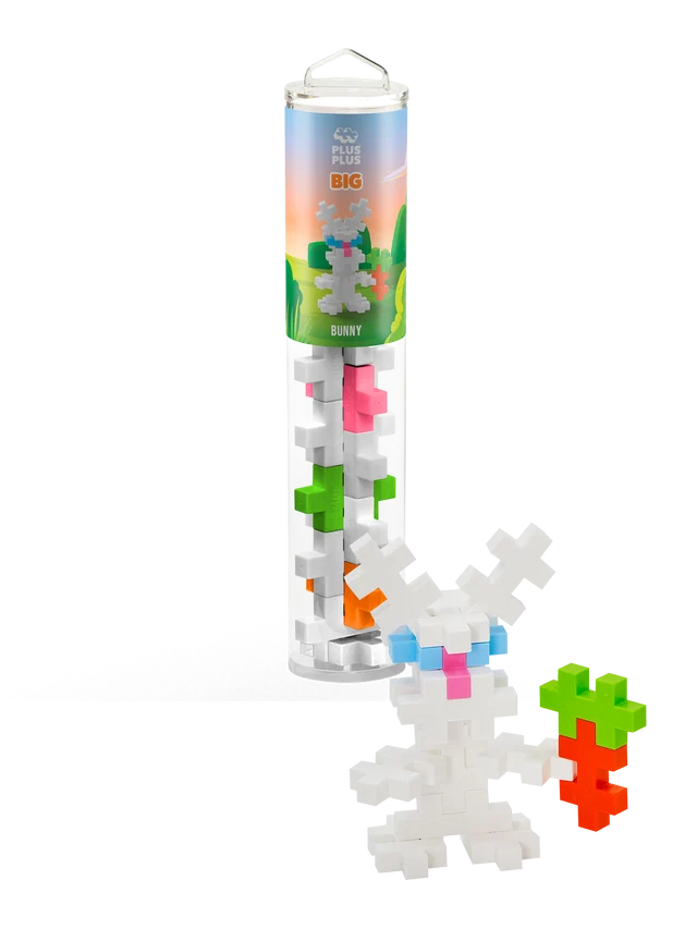 Interlocking plus-shaped building blocks in a tube next to a built white bunny figure holding a block carrot.