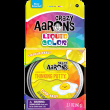 Yellow Crazy Aaron's Over Easy Thinking Putty in a metal tin with egg graphic and Liquid Color packaging.