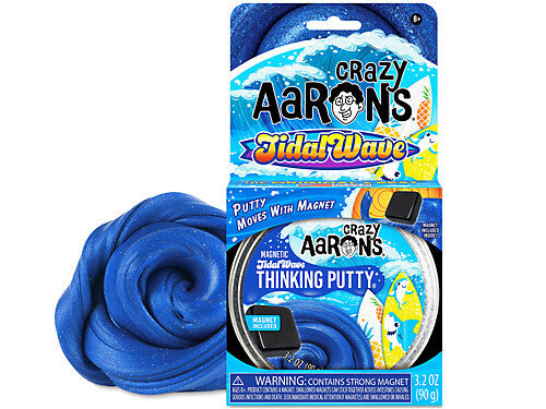 Deep blue shimmering magnetic thinking putty swirled next to its packaging and a small black rectangular magnet.