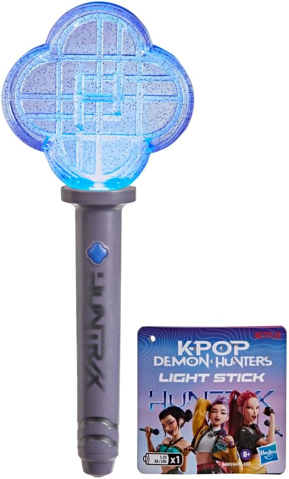 Blue glittery four-leaf clover light stick with a grey HUNTRAX handle and K-Pop Demon Hunters packaging tag.