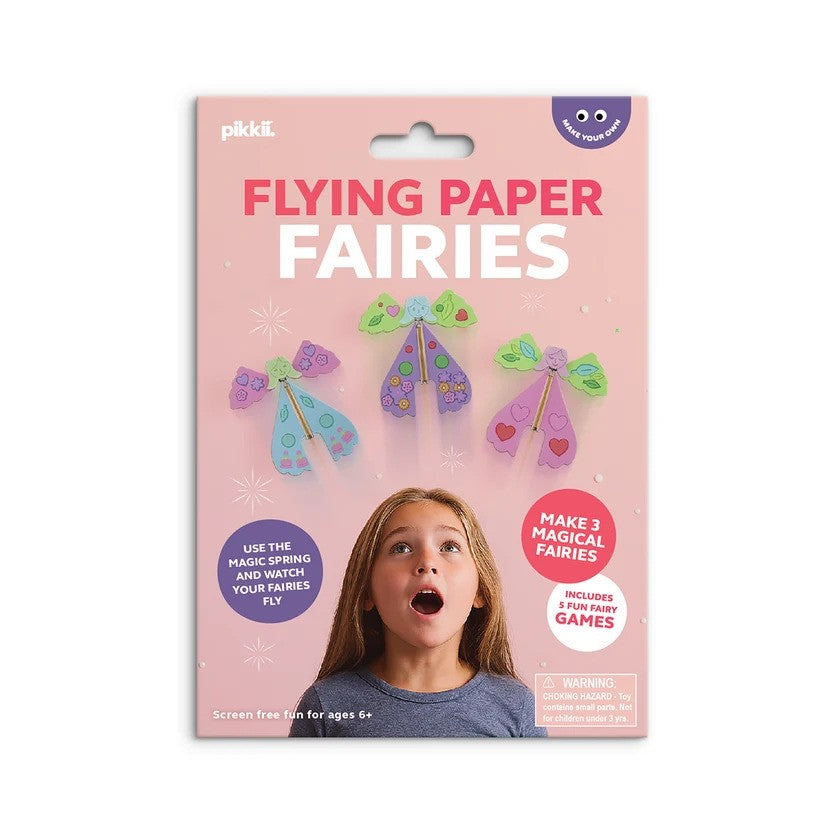 Pink packaging for Flying Paper Fairies kit showing three colorful paper fairies and a surprised young girl.