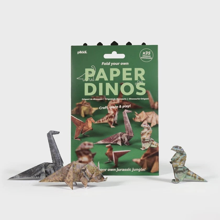 Green Paper Dinos origami packaging showing 35 models with four folded dinosaur figurines on a white surface.