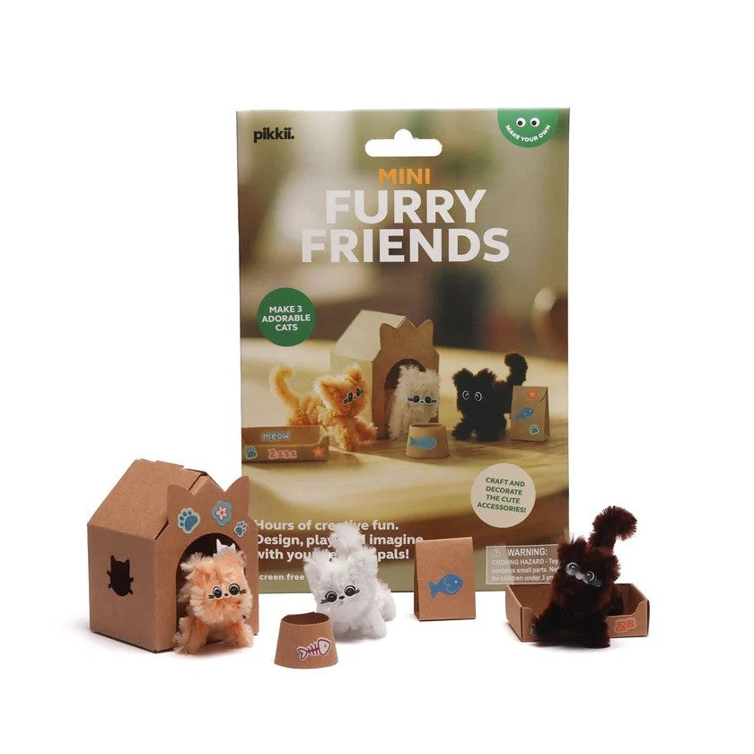 Pikkii Mini Furry Friends craft kit featuring three small fuzzy cats and a cardboard playhouse on a white background.