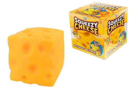 A square yellow squishy toy with holes resembling Swiss cheese beside its orange and yellow box.