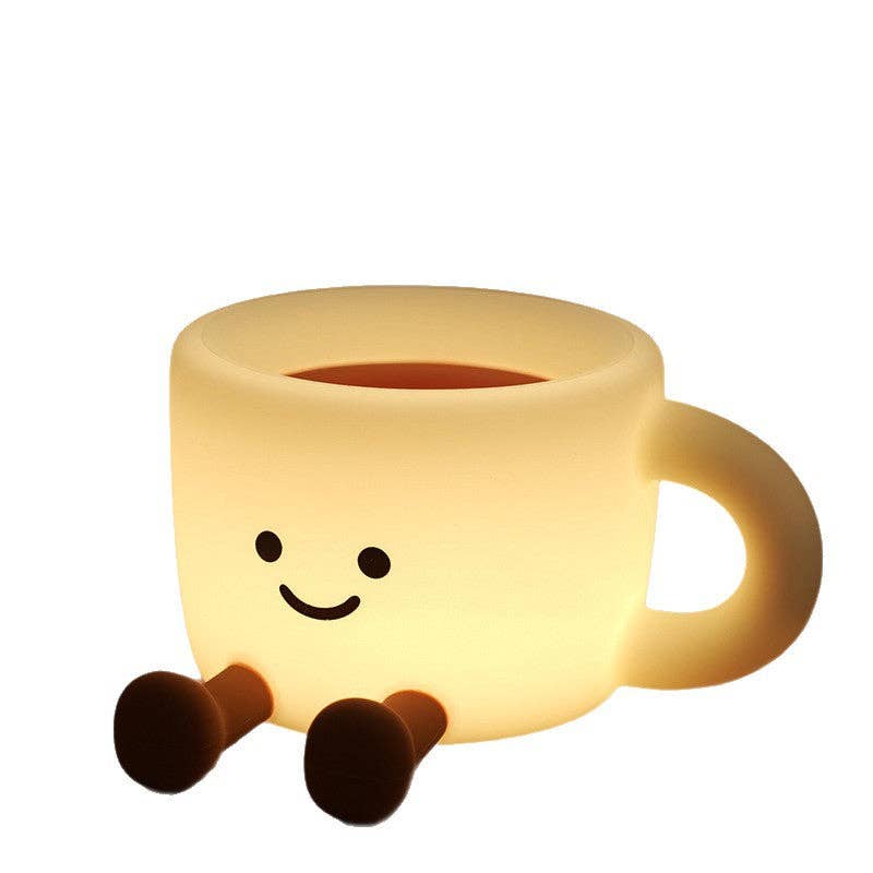 Glowing yellow coffee cup night light with a smiley face and two tiny brown legs, made of soft silicone.