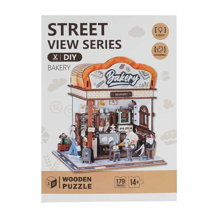 Product packaging for a Street View Series 3D wooden bakery puzzle with 179 pieces and an LED light feature.