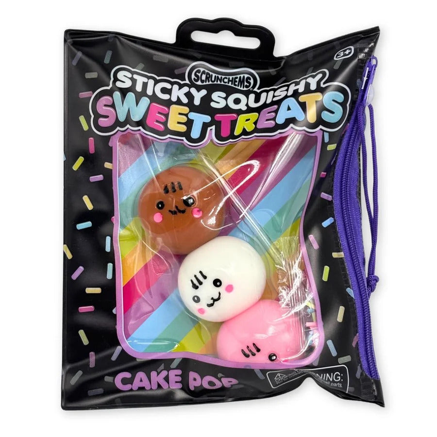A black zippered bag containing three squishy cake pop toys with cute faces in brown, white, and pink.