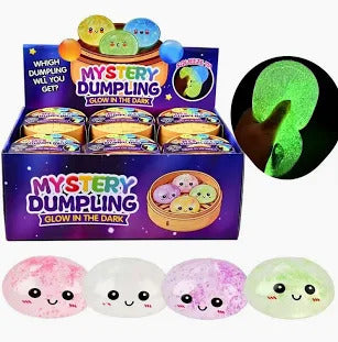A display box of Mystery Dumpling Glow in the Dark squishies featuring cute faces and a glowing visual effect.