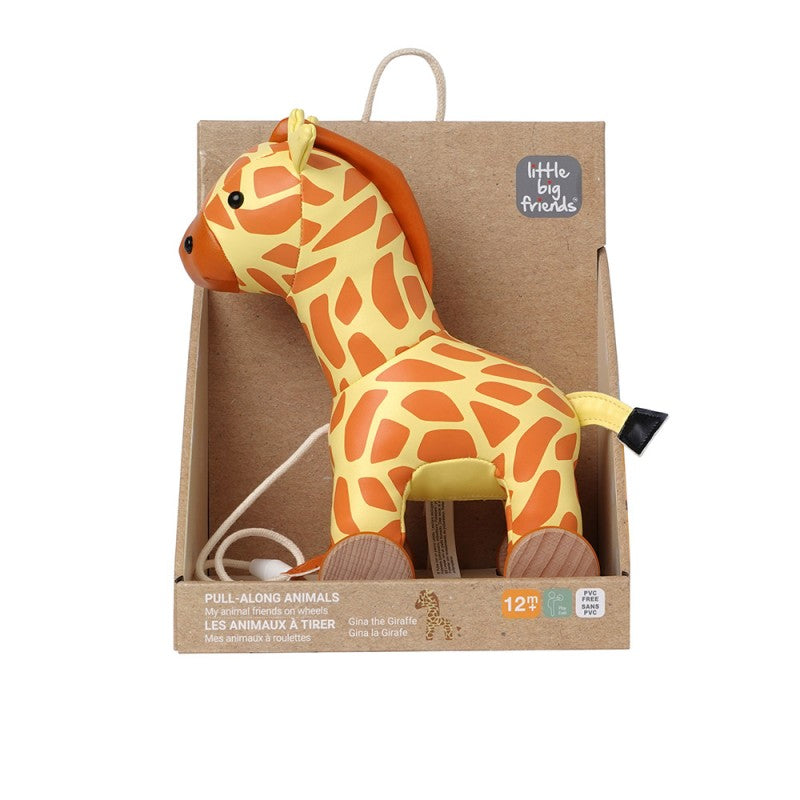 Yellow and orange patterned giraffe pull-along toy with wooden wheels and a white cord in a cardboard display box.
