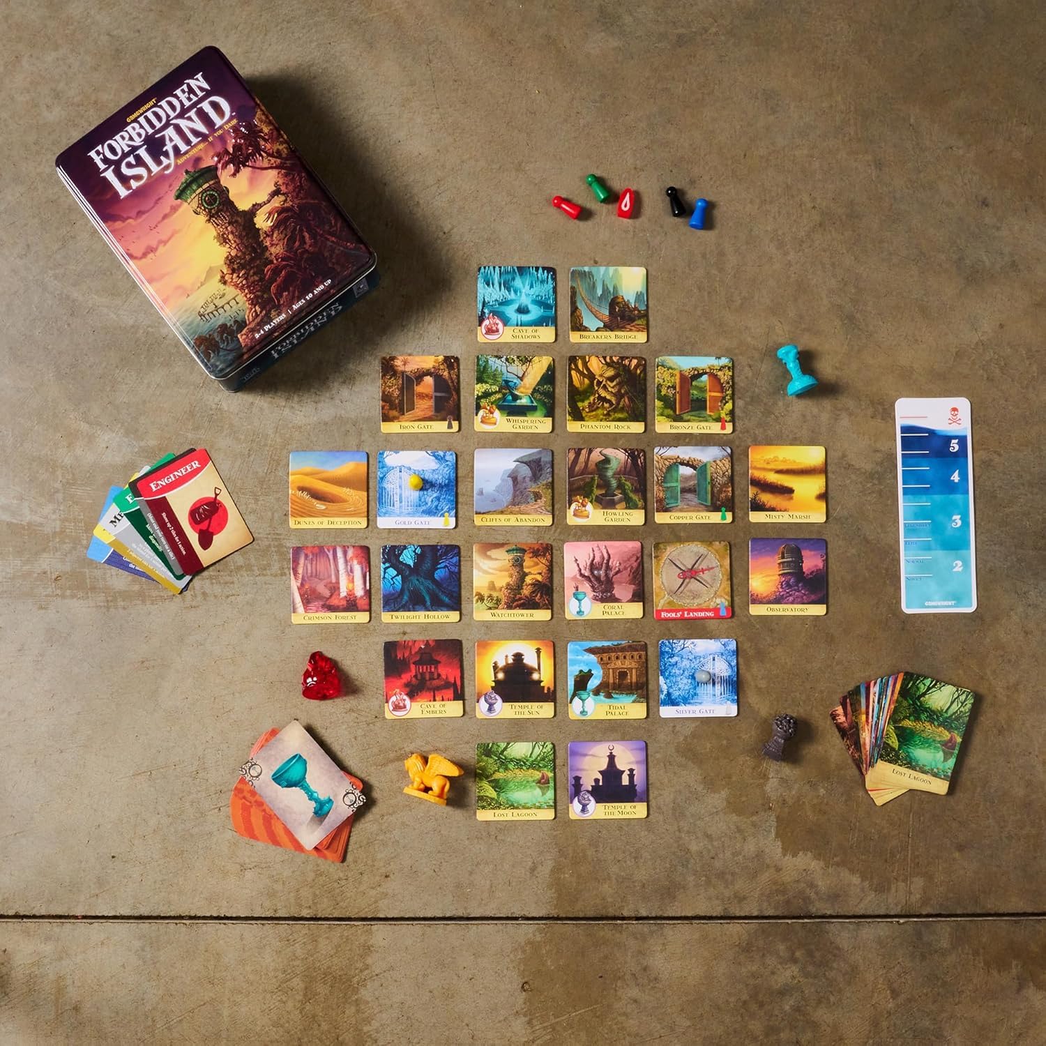 Board game components including cards and pieces on a textured surface