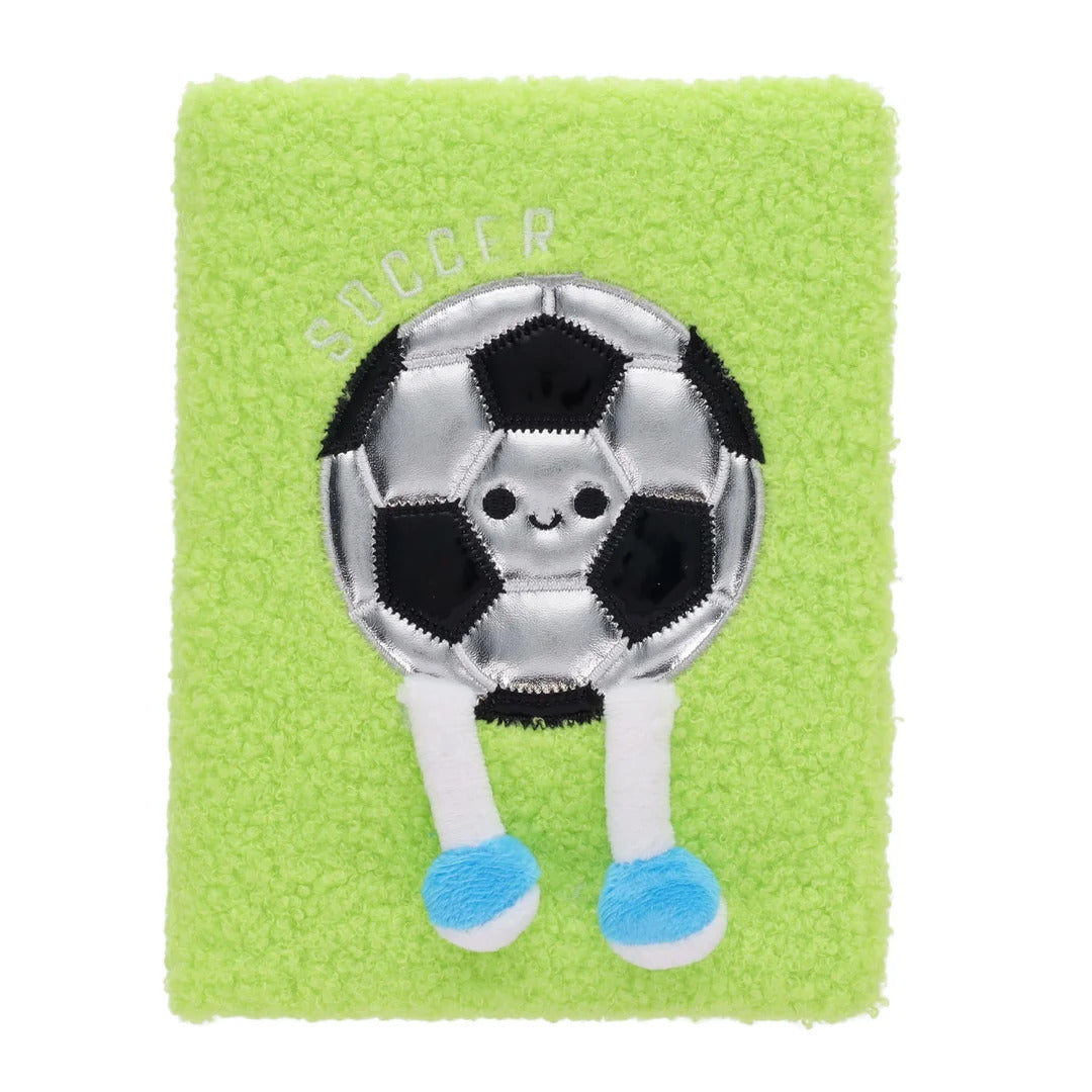 Bright green fuzzy notebook with a cute metallic soccer ball character featuring a face and dangling legs.