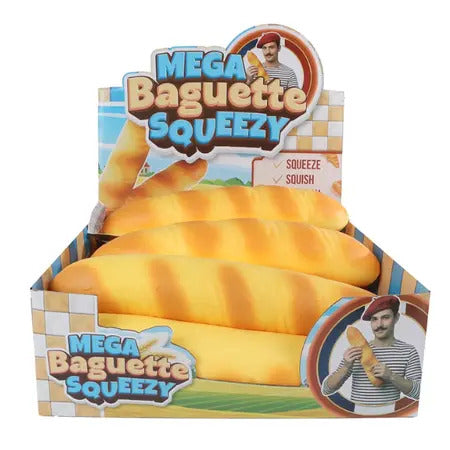 Large realistic baguette-shaped squishy toy in a themed display box featuring a French baker illustration.