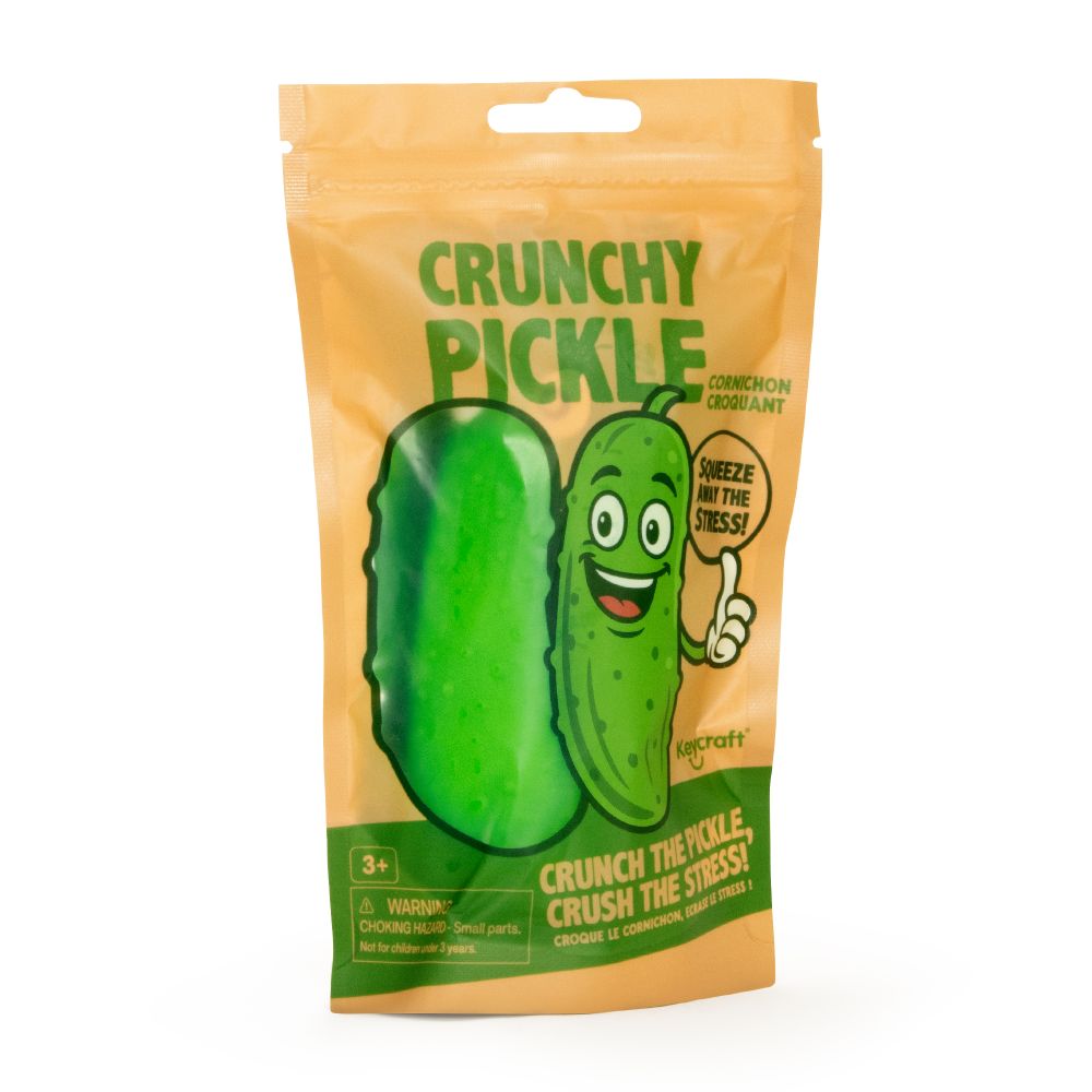 A green bumpy pickle-shaped stress toy packaged in a bright orange pouch with a smiling cartoon pickle.