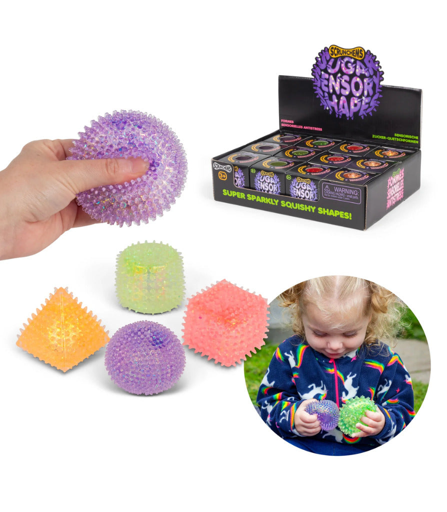Colorful spiky squishy geometric shapes in purple, orange, green, and pink, shown with a display box and a child.
