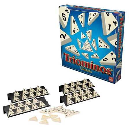 Blue Triominos Classic box next to triangular numbered tiles and four black plastic tile racks on a white background.