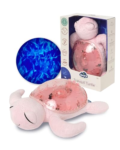 Pink plush turtle with a translucent shell shown next to packaging and a blue wave light projection graphic.