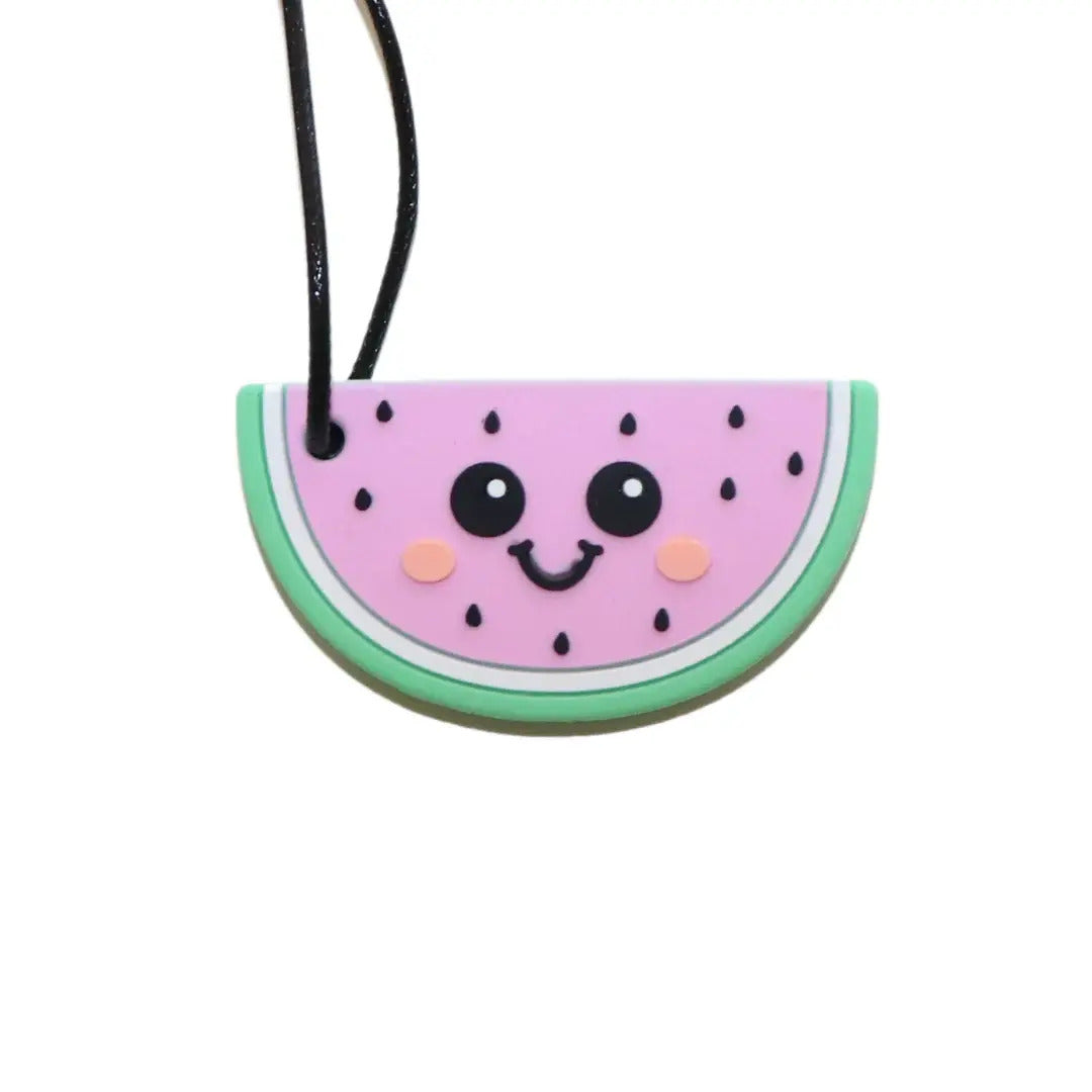 A pink watermelon-shaped silicone chew necklace with a cute smiling face and green rind attached to a black cord.