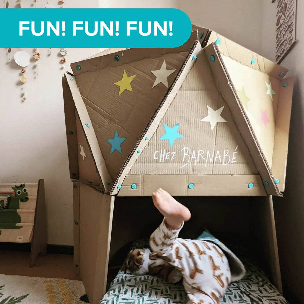 Child playing in a cardboard fort held together by blue Makedo fasteners and decorated with colorful stars.