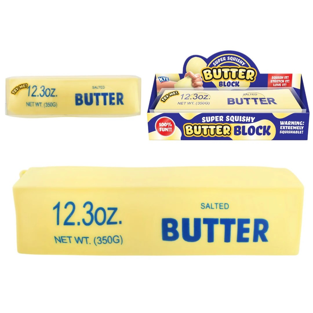 Yellow rectangular squishy toy printed with 'SALTED BUTTER' and '12.3oz' in blue text, shown next to its packaging.