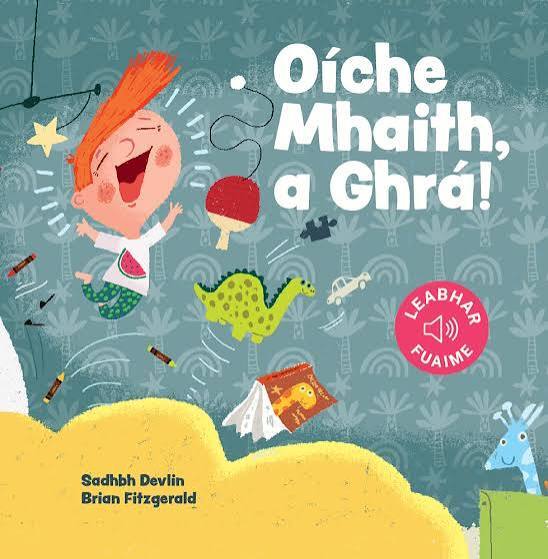 Cover of Irish children's sound book 'Oíche Mhaith, a Ghrá!' featuring a cartoon boy, a dinosaur, and various toys.