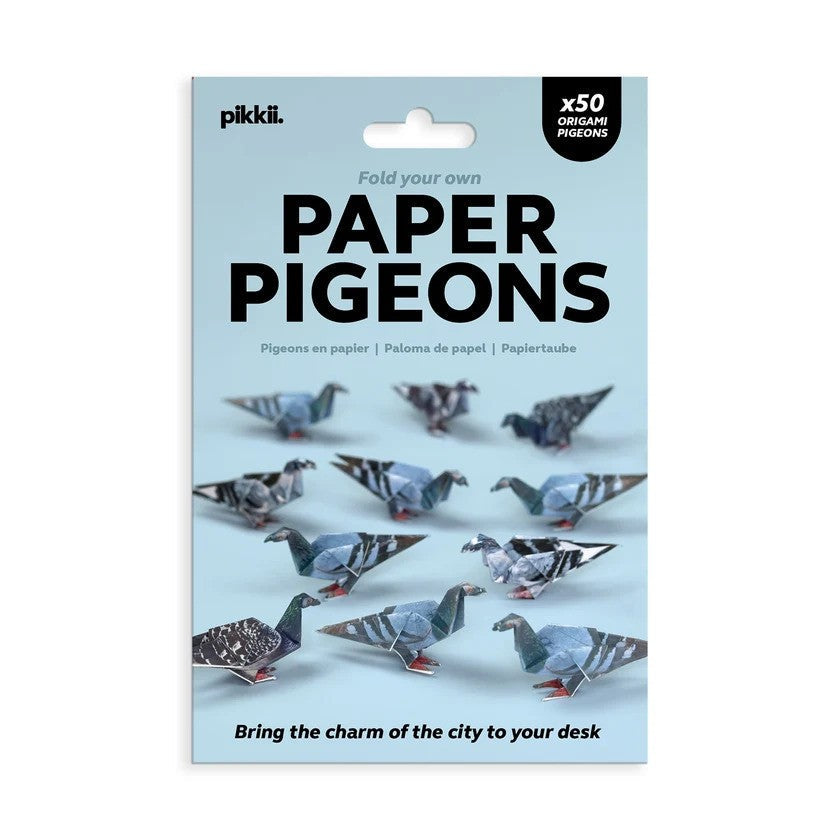 Blue packaging for Pikkii Paper Pigeons kit showing several realistic folded origami pigeons with grey and blue feathers.