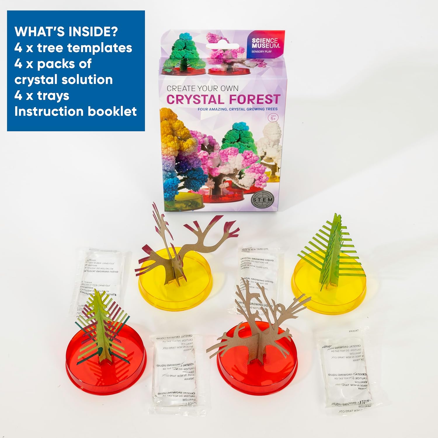 Crystal kit with 4 cardboard trees, solution packs, and red and yellow trays shown in front of the product box.