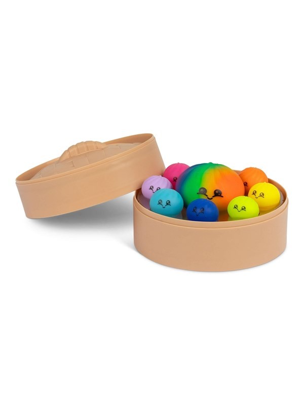 Colorful squishy balls with smiley faces in a tan plastic dim sum steamer basket with an open lid.