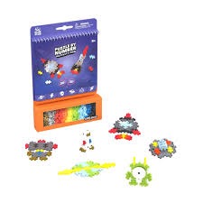 Purple and orange Puzzle by Number box with space-themed plastic building pieces and completed rocket and alien models.