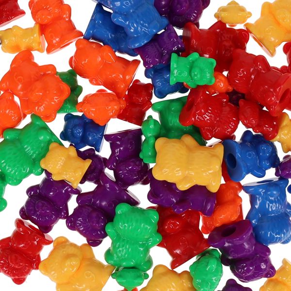 A pile of colorful, small plastic bear-shaped figurines in red, orange, yellow, green, blue, and purple.