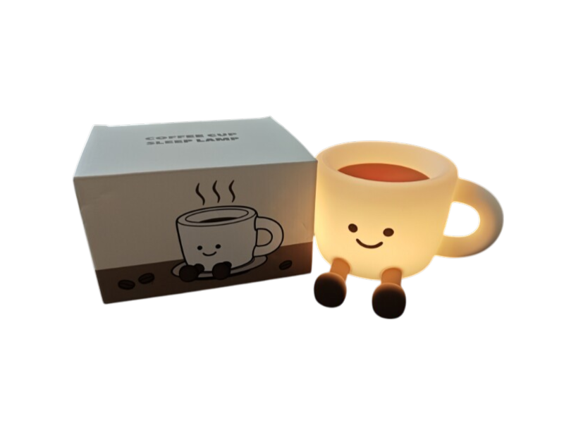 Warm glowing smiley coffee cup lamp with legs next to its white and brown illustrated packaging box.