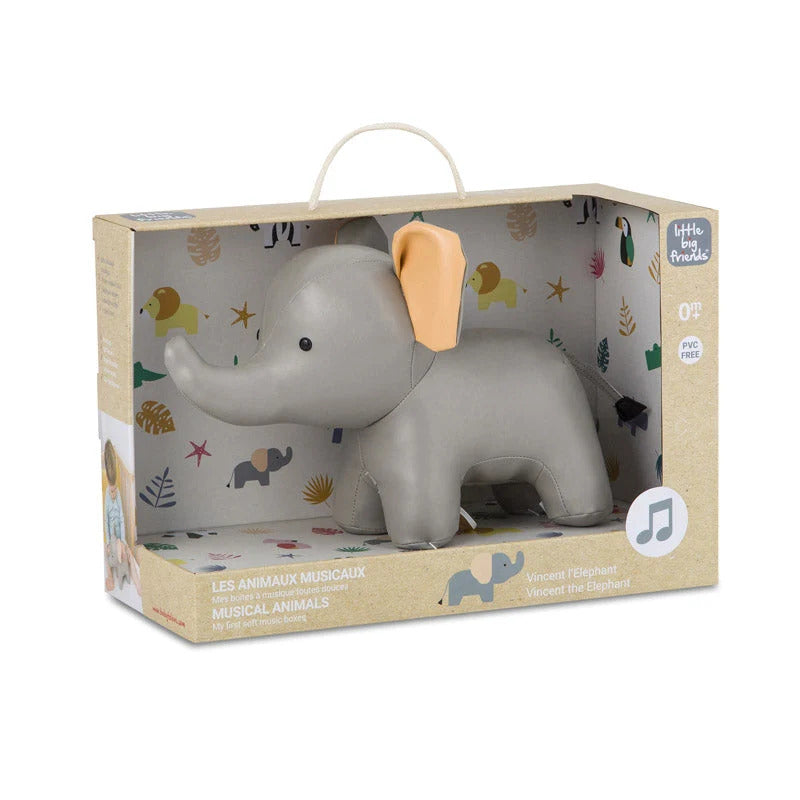 A grey soft elephant toy with a tan ear inside a decorative cardboard box labeled Musical Animals Vincent the Elephant.