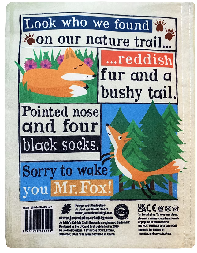 A square fabric patch or label with a printed woodland fox-themed design. The cream fabric background features illustrated panels with a sleeping orange fox, flowers, trees, and text reading phrases like 'Look who we found on our nature trail.