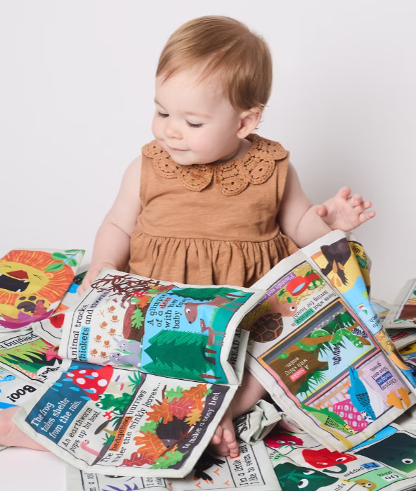 Child surrounded by colorful books with animal illustrations on a white background