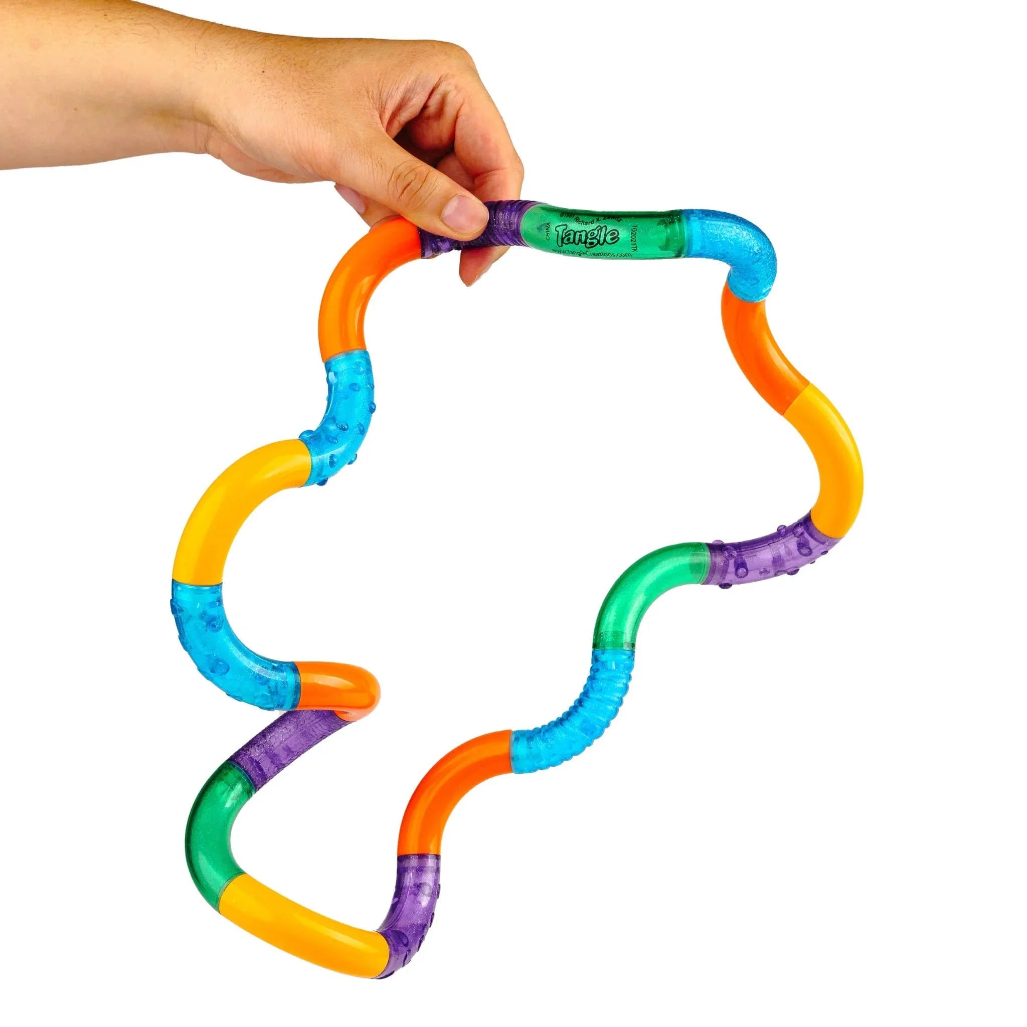Colorful tube toy being held by a hand on a white background