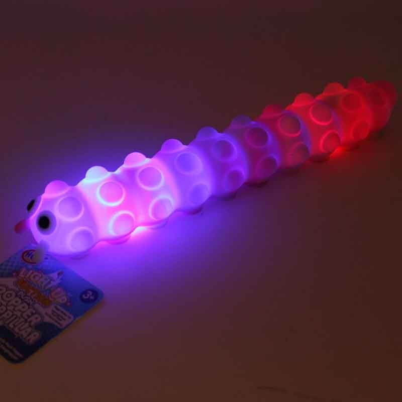 Glowing caterpillar toy with push pop bubbles, illuminated with blue and red lights on its translucent body.